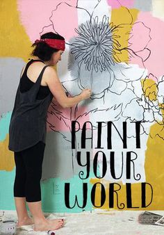 a woman painting a flower on the side of a wall with words paint your world above it