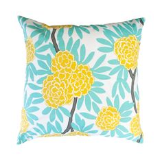 a blue and yellow pillow with large flowers on the front, against a white background