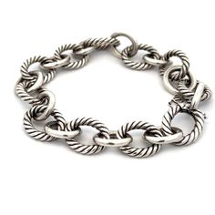 "This is an authentic chain bracelet is by David Yurman, it is crafted from sterling silver featuring large oval links in alternating pattern of cable style silver links with oval polished links. It secures with an invisible oval link hook clasp, and it is signed by the designer with the silver content. Material:  sterling silver Hallmark:  D.Y 925  Measurements:  7.75\" to 8\" long x 0.50\" wide x 0.45\" high Weight:  34.9 grams Stock# 68118" Luxury Bracelet With Cable Chain And Oval Link, Luxury Bracelets With Cable Chain And Oval Link, Classic Sterling Silver Bracelet With Chunky Oval Links, Classic Sterling Silver Bracelet With Chunky Chain, Silver Oval Link Chain Bracelet With Cable Detail, Silver Cable Chain Bracelet With Oval Links, Classic Sterling Silver Bracelet With Cable Chain, Silver Oval Link Chain Bracelet, Classic Oval Metal Chain Bracelet