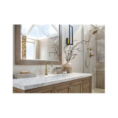 a bathroom with marble counter tops and wooden cabinets