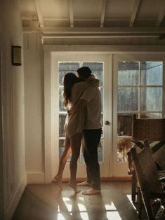 two people embracing in front of a door