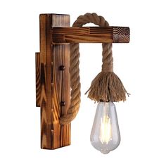 a light that is hanging from a wooden beam with rope and bulb attached to it