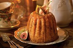 a bundt cake with figs and caramel drizzled on top