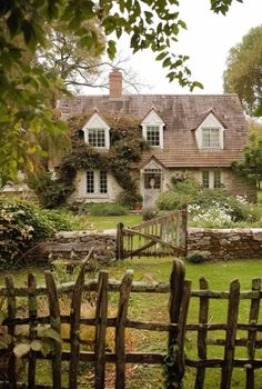 a house with a wooden fence in front of it