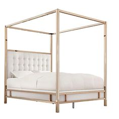 a white bed with a metal frame and headboard is shown against a white background