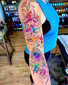 a woman's arm with flowers painted on it