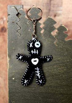 a keychain with a black and white teddy bear on it