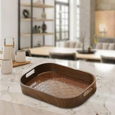 a wooden tray sitting on top of a white counter