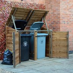 an outdoor area with trash cans and bins