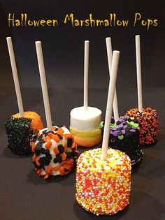 halloween marshmallow pops are lined up on a table