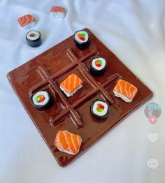 there are sushi on the chocolate plate