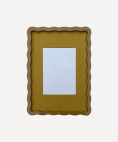 a small square shaped object with a white surface in the middle and brown frame around it