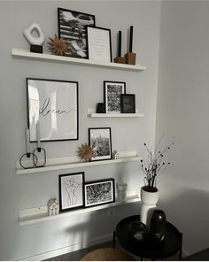 some white shelves with black and white pictures on them