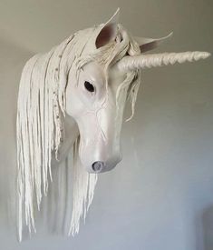 a white horse head hanging on the wall