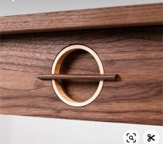 a close up of a wooden door with a ring on the front and back of it