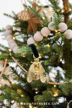 an ornament hanging from the top of a christmas tree