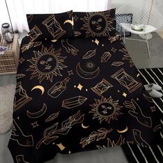 black and gold bedding with sun, moon, stars and other things on it