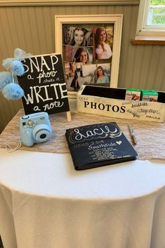 a white table topped with pictures and books