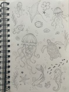 a notebook with some drawings on it and an octopus, jellyfish, seahorse, turtle