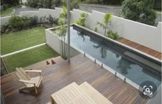 a wooden deck next to a swimming pool