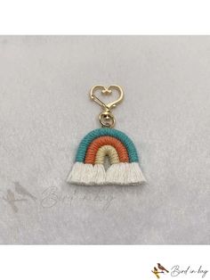 a keychain with a rainbow on it and a heart hanging from the end