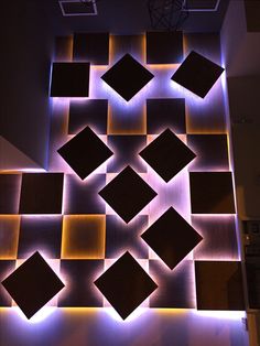 an abstract wall made up of squares and cubes with lights on the bottom floor