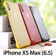 three iphone xs max cases sitting next to each other on top of a box