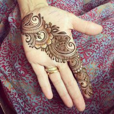 the hand is decorated with henna designs