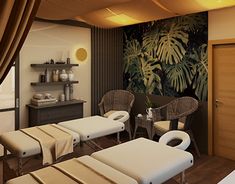 a spa room with two massage tables and chairs in front of a large wall mural