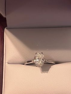 a diamond ring sitting in a box on top of a table