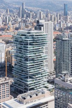 an aerial view of a city with tall buildings and skyscrapers in the foreground