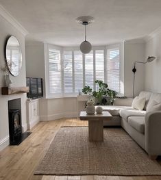 a living room filled with furniture and a fire place