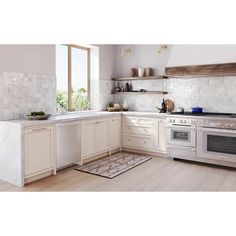 a kitchen with white cabinets and an oven in the center, along with a rug on the floor