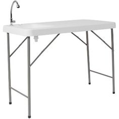 a white sink sitting under a faucet on top of a metal frame table