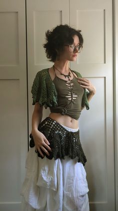 a woman wearing a skirt and crop top