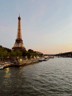 the eiffel tower is lit up at night