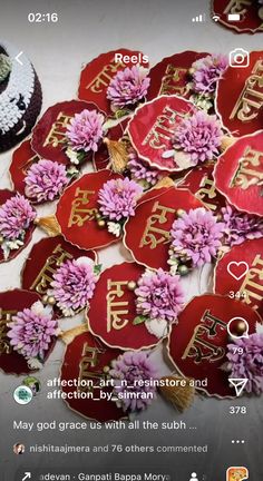 some red and white plates with pink flowers on them next to a cake that has chinese writing on it