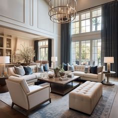 a living room filled with lots of furniture next to a large window covered in curtains