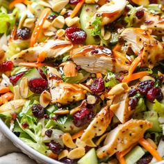 a salad with chicken and cranberries in it