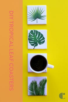 a cup of coffee sitting on top of a table next to coasters with leaves