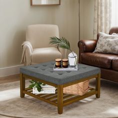 a living room with a couch, chair and coffee table in it's center