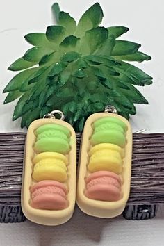 two ice cream pops are sitting in front of a fake pine tree and green leaves