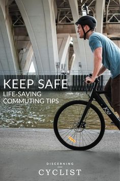 a man riding a bike down a street next to a bridge with the words keep safe life - saving commuting tips