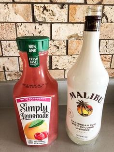 two bottles of ketchup sit next to each other on a counter