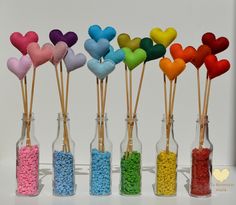 there are many heart shaped candy sticks in the bottles