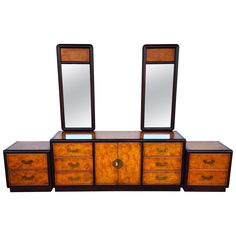 a wooden dresser with two mirrors on it's top and drawers below the mirror