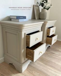 a white dresser with three drawers and a book on top, next to a potted plant