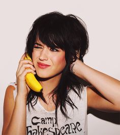 a woman holding a banana and talking on the phone