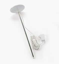 an electronic device is plugged in to a wall charger with a white cord