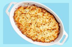 a casserole dish with cheese and onions in it sitting on a blue background